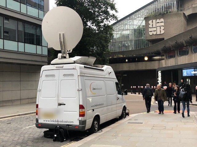 The van in its former working life as a live-events uplink truck, satellite dish fully deployed outside the Barbican Centre in London